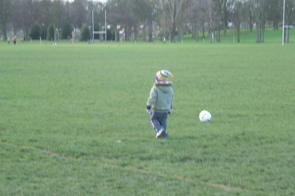 Kicking the football around.