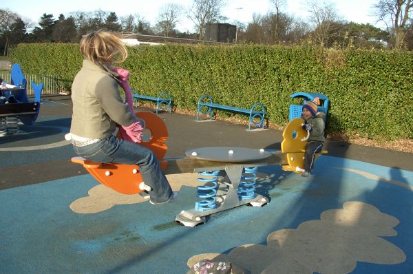 Catherine and Robin play on the seesaw.